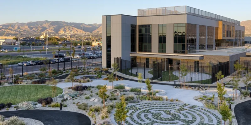 Landscaped courtyard with winding paths and mountains beyond